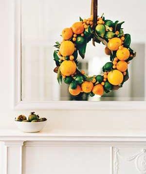 Get fruity. Tired of conventional evergreen? Try an aromatic blend of fruits for your holiday wreath. Image via Real Simple.